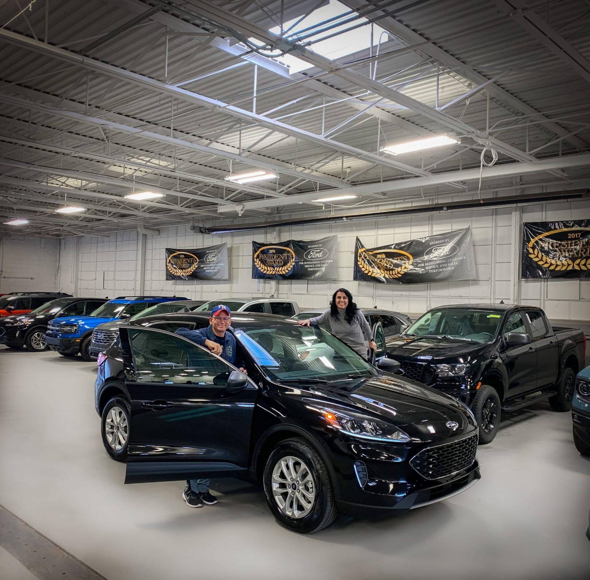 Bill Brown Ford customers outside of their new 2022 ford Escape Hybrid