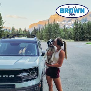 Women kissing her dog outside in front of her new Bronco Sport from Bill Brown Ford in Livonia, MI.